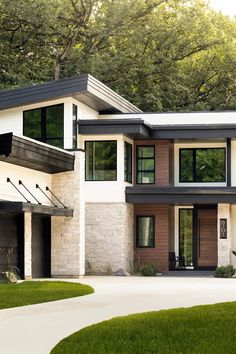 a large modern house with two garages on the front and one above it's entrance