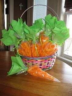 a basket filled with carrots sitting on top of a wooden table