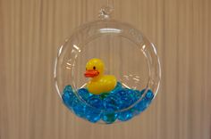 a glass ornament with a rubber duck in it