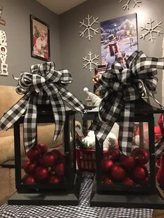 two christmas decorations are sitting on a table