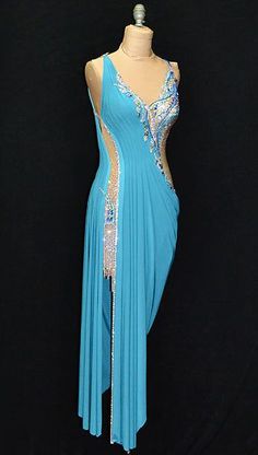 a woman's blue dress on display in front of a black background