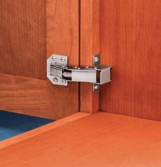 a close up of a door handle on a wooden door with blue carpet and wood paneling