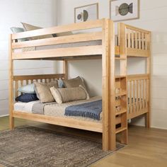 a wooden bunk bed sitting on top of a hard wood floor next to a rug