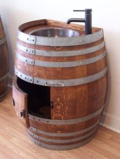 a wooden barrel sink sitting on top of a hard wood floor