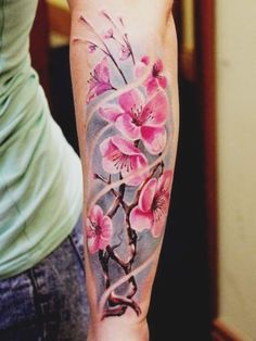 a woman's arm with pink flowers on it