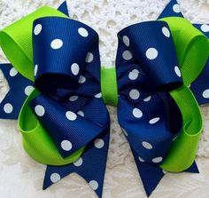 a blue and green bow with white polka dots