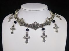 Victorian Gothic metal choker with hollow crosses and black crystal beads, ornate metal necklace, Victorian jewelry, Gothic jewelry A beautifully ornate gothic silver metal choker with Victorian hollow cross charms and black faceted crystal beads. It measures approx. 11 inches in length and has lobster clasp fastening and an extension chain, so that it can be adjusted to fit the neck. The choker is made up of 7 silver toned metal ancient style sections that have intricate detailing. A marvelous Gothic Metal Choker For Festivals, Ornate Metal Choker Necklace, Victorian Metal Choker Jewelry, Victorian Metal Choker Necklace, Gothic Metal Cross Pendant Jewelry, Gothic Metal Cross Jewelry, Gothic Cross Pendant Jewelry, Victorian Style Metal Choker Necklace, Gothic Cross Necklace For Festivals