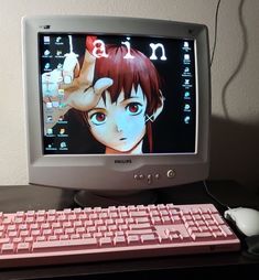 a desktop computer with an anime character on the screen and keyboard in front of it