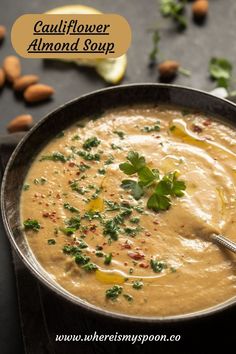 a bowl of cauliflower almond soup with a spoon in it