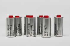 four batteries with red caps are lined up on a white surface in front of each other