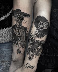 two people with tattoos on their legs and one has a skull in the middle, while the