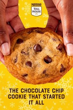 the chocolate chip cookie that started it all is being held up by someone's hands