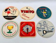 six vintage coasters are arranged on a white surface