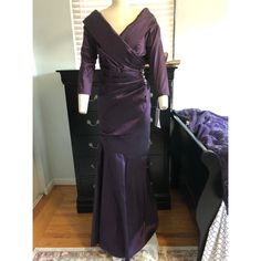 a mannequin wearing a purple dress in front of a mirror