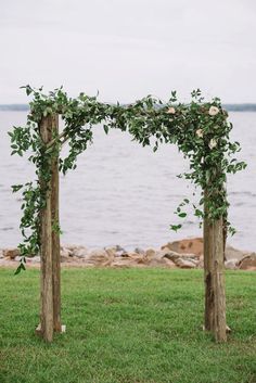 an image of a wedding arch made out of branches and flowers on the grass with text reading romantic lakeside navy and bush wedding article from every last