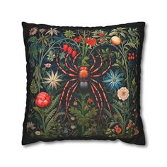 a decorative pillow with an image of a spider in the middle of flowers and foliage