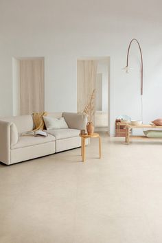 a living room filled with furniture and white walls