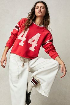 Add the perfect touch of retro-inspired style to any look with this timeless crewneck sweatshirt featuring varsity number and stripe detail at sleeves for added dimension. * Slouchy fit * Scoop neckline * Light distressing throughout * Raw bottom hemline | Retro Sport Sweatshirt by Original Retro Brand at Free People in Red, Size: L Cropped Graphic Tees, Graphic Tee Style, 90s Looks, Retro Sport, Retro Brand, Red Fits, Sports Sweatshirts, Vintage Sweatshirt, Free Clothes