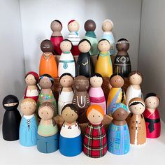 a group of wooden dolls sitting next to each other