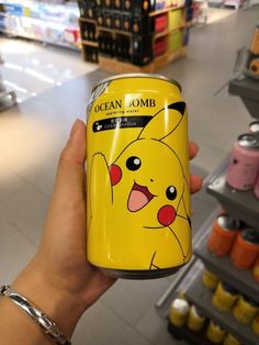 a person holding up a can of pikachu lombo in a store aisle