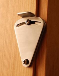 a close up of a door handle on a wooden door