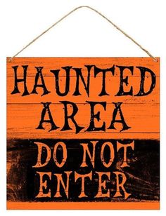 a wooden sign that says,'haunted area do not enter'on an orange and black background