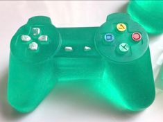 a close up of a video game controller on a white surface with other controllers in the background