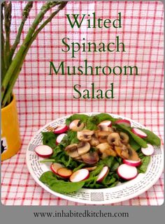 a white plate topped with salad next to a yellow vase filled with green beans and radishes