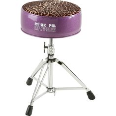 a purple drum stool with a leopard print seat cover on it's back and legs