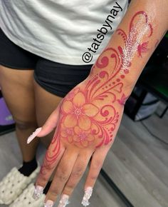 a woman's hand with red and white designs on it