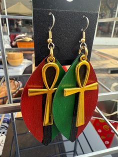 Introducing our stunning Large Red, Black, and Green Africa Earrings with gold colored Ankh symbol - a bold statement piece that celebrates the vibrant culture and artistry of Africa. These unique earrings are handcrafted with care, featuring intricate designs that showcase the rich heritage and colors of the continent. **Product Details - **Design Each earring features a striking combination of red, black, and green hues, symbolizing unity and strength. The large size adds a dramatic flair, mak Afrocentric Earrings, Ankh Symbol, Africa Earrings, African Earrings, Fabric Earrings, Green Hues, African Jewelry, Intricate Designs, Unique Earrings