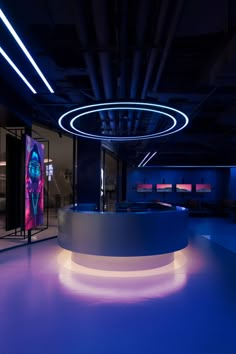 an empty room with blue lighting and circular counter