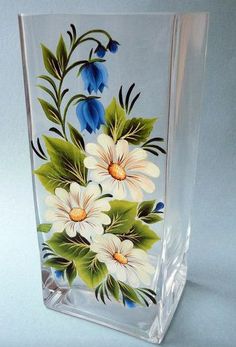 a glass vase with flowers painted on it