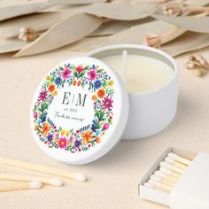 the personalized candle is next to some matches