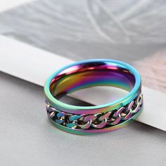 A Gorgeous Spinner Ring In Vibrant Rainbow Colors. The Chain Actually Spins And Is Perfect For Someone Who Fidgets With Their Ring! Colors Are Plated Over Sturdy Stainless Steel And Is Highly Polished. Perfect To Wear As A Wedding Or Commitment Ring Or As A Special Way To Display Your Pride! You Can’t Go Wrong With This Beauty! ***Second Picture Is For Information Only. First Picture Is The Actual Appearance Of Colors.*** More Sizes Available Soon! Gay Pride Lesbian Homosexual Bi Sexual Transgender Promise Engagement Bottle Opener Ring, Support Portable, Punk Women, Gold Color Ring, Moss Agate Ring, Fidget Rings, Purple Necklace, Princesa Diana, Spinner Ring