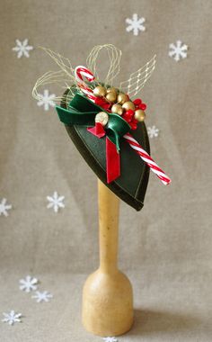 a small green hat with candy canes on it