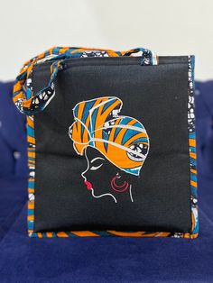 Made by Africa's finest, the cutest most durable tote bag with African print embellishment and embroidery. Whwt makes this bag unique is the fact that this bag is furnished with embroidered images of African beautiful women and embellished with strong vibrant African Print Fabric. This cotton vibrant African Fabric is also used around the rest of the bag which includes the handles.  This tote bag can be used for every day use, to the beach, to lectures, brunch afternoons, church, work. It can fi Black Square Cotton Bag, Black Large Capacity Lunch Bag Gift, Large Capacity Black Lunch Bag As Gift, Large Capacity Black Lunch Bag For Gift, Large Capacity Black Lunch Bag Gift, Handmade Black Canvas Bags, Square Canvas Shoulder Bag For Gift, Embroidered Rectangular Canvas Bag, Square Canvas Shoulder Bag Gift