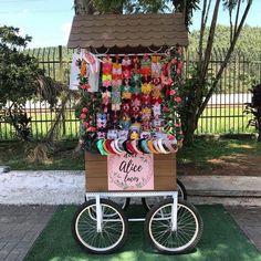 a bike with a cart full of bracelets on the back and a sign that says we are alice jones