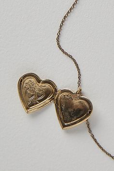 A super sweet gift or an accessory unique to you, this darling monogram necklace features a heart locket pendant with an initial engraving. **Features:** Dainty chain, heart locket pendant, hinge opening mechanism, monogram initial engraving, clasp closure **Why We | Monogram Necklace by Free People in Gold Unique Locket, Engraved Locket, Gold Heart Locket, Gold Locket Necklace, Chain Heart, Sweet Necklace, Engraved Pendant, Gold Locket