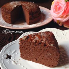 there is a piece of chocolate cake on the plate and another slice has been cut