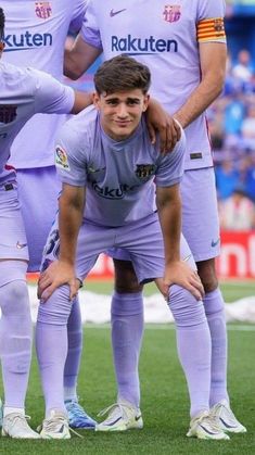 three soccer players are posing for a team photo