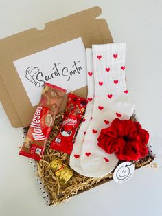 the valentine's day gift box is packed with candy and socks