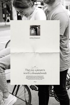 a man and woman standing next to each other holding up a piece of white paper