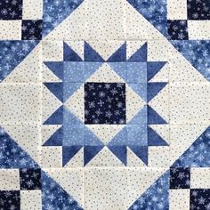 a blue and white quilt with snowflakes on the top, as if it were made out of fabric