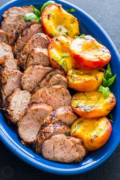 a blue bowl filled with meat and vegetables