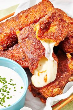 some fried food is on a plate with dipping sauce