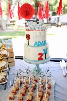 there is a cake and cupcakes on the table