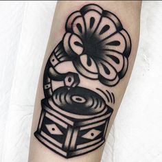 a black and white photo of a record player tattoo