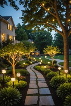 a garden path with lights and trees in the background