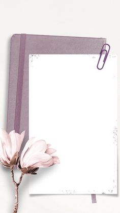 a notepad with a flower on it next to a pair of scissors